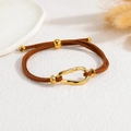 Detail of adjustable brown suede cord bracelet with a vintage oval gold metal charm - Gold Irregular Smooth Style (M-B1283-02-C)