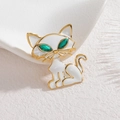 Elegant 18k gold kitten brooch with white enamel body and green crystal gemstone eyes - Cat