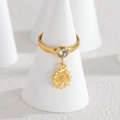 Gold-plated sunflower ring with a sparkling clear crystal on a white cone stand - Sunflower
