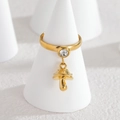 18k gold mushroom charm ring with clear round zircon set on a white display stand - Mushroom