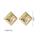 Detailed view of square vintage gold earrings with colorful zircon and floral texture - Square
