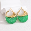 Retro gold hoop earrings with bright green irregular resin charms on white props - Dark Green