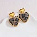 18k gold heart-shaped earrings with leopard print inlays on a white ceramic tray - Gray