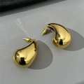 Minimalist gold-plated teardrop earrings with high-polish finish on leather background - Large / Gold