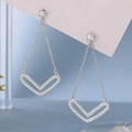 24K gold plated long V-shaped drop earrings with micro-pave crystals on a blue background - Silver