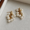 Macro shot of elegant grape-shaped cluster pearl earrings with gold-tone hardware detail - Gold