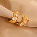 Macro shot of gold hoop earrings with sparkling cubic zirconia on a silk background - 24K Gold Plated Color / Gold