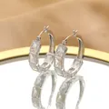 Detail of silver S925 hoop earrings with baguette-cut white zircon on a mirror tray - Silver