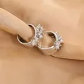 Macro detail of silver hoop earrings with clear cubic zirconia on champagne silk fabric - 24K Gold Plated Color / Silver