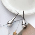 Polished silver teardrop earrings with a sleek minimalist design on a ceramic tray - 18K Gold / Silver