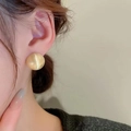 Elegant gold brushed metal spherical stud earrings shown on model in side profile - Gold (A0218B)
