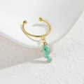 Golden ear cuff with a light green enamel seahorse pendant in a minimalist marine style - Seahorse Style (M-R857) / Green