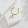 Detail shot of golden hoop earring with a pink enamel dolphin pendant on a stone base - Dolphin Style (M-R858) / Pink