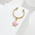 Macro detail of gold horseshoe jewelry with a pink star pendant on white blocks - Starfish Style (M-R864) / Pink