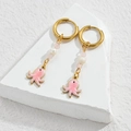 Golden octopus drop earrings with pink oil drip, pearls, and beads on a white stone base - Pink Octopus Style
