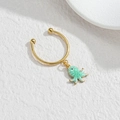 Detailed close-up of a golden earring featuring a mint green octopus drop with sea texture - Octopus Style (M-R866) / Green