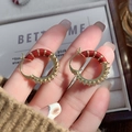 Detail of gold caterpillar earrings with red enamel coating and inlaid sparkling crystals - Gold Style (A0625C)