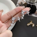 Detail of silver starburst earrings featuring pavé cubic zirconia in a long star shape - Silver (A0804A)