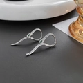 Macro detail of silver snake hoop earrings with green zircon eyes and scale texture - Silver (A0632A)