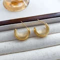Minimalist C-shaped stud earrings in matte gold finish for a modern metal texture look - Gold