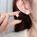 Close-up of 8mm round pearl earrings with gold plating on a model for a vintage French look - Platinum Plated Pin Style