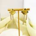 Macro detail of gold-plated tassel earrings with zircon studs on a display stand - Rhombus Tassel Style (A1301-04C) / Gold