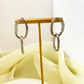 Detail of silver oval earrings with mesh texture on a gold stand with satin background - Silver (A1301-05C)