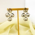 Detail of silver geometric earrings with sparkling zircon stones on a T-bar display stand - Silver
