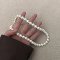 Detail of elegant white pearl necklace with gold lobster clasp held in hand - 10mm Pearl Necklace (A0265A-4) / White