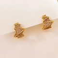 Macro shot of geometric gold earrings with micro-pave sparkling cubic zirconia stones - Diamond-Cut Surface / Gold