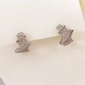 Macro detail of geometric silver studs featuring shimmering pavé set zircons - Diamond-Cut Surface / Silver