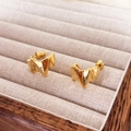 Detailed close-up of golden irregular geometric stud earrings with sparkling cubic zirconia - Glossy / Gold