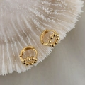Detail of 18K gold plated geometric huggie hoop earrings on white coral texture - Gold (A0438A)
