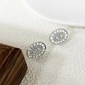 Macro shot of silver hollow link earrings featuring micro-set zircon on textured surface - Silver