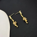 Close-up of golden snake tassel earrings with sparkling zircon inlay on 18K gold plating - Gold (A0838C)