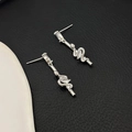 Detail of silver snake drop earrings with sparkling cubic zirconia on a textured background - Silver (A0838C)