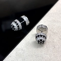 Macro shot of 18K gold-plated stud earrings with black and white pavé-set cubic zirconia - Silver
