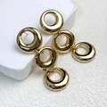 Detailed macro view of triple linked gold circle chain earrings on a white stone pedestal - Triple Interlocking Circle Style (A0223C Gold) / Gold