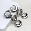 Macro detail of high-polish silver interlocking triple ring chain earrings on stone - Triple Interlocking Circle Style (A0223C Silver) / Silver