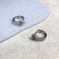 Detailed view of silver snake huggie earrings with micro-pave cubic zirconia and green eyes - Snake Style (A0205C) / Silver