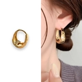 Golden chunky hoop earrings with textured hammered finish shown on model and product view - Chunky Hammered Huggies (A0476A) / Gold