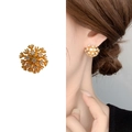 Golden snowflake stud earrings with sparkling cubic zirconia in a radial cluster design - Gold