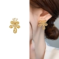 Gold twisted bow flower earrings with cubic zirconia shown in product and on-ear view - Gold