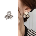 Silver triple-petal flower stud earrings with center crystal accent on a model - Bright Silver
