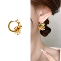 Elegant gold flower hoop earrings featuring sparkling cubic zirconia and intricate metal petals - Gold