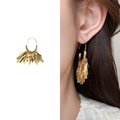 Golden fringe earrings with rectangular metal tassels shown on a model for scale - Gold