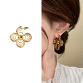 Hollow gold four-leaf clover stud earrings showing individual piece and model wearing effect - Gold