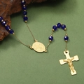 Macro detail of religious rosary necklace with blue faceted beads and golden crucifix pendant - Gold Style A-Blue Bead