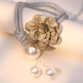 Detail of a braided necklace with a sparkling diamond flower and pearl drop pendant - Necklace and Earring Set / Grey Green