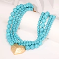 Detail of turquoise beaded multilayer necklace featuring a gold hammered heart pendant - Heart Pendant Necklace